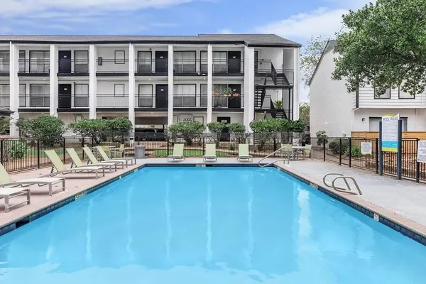 a swimming pool view with a outdoor seating