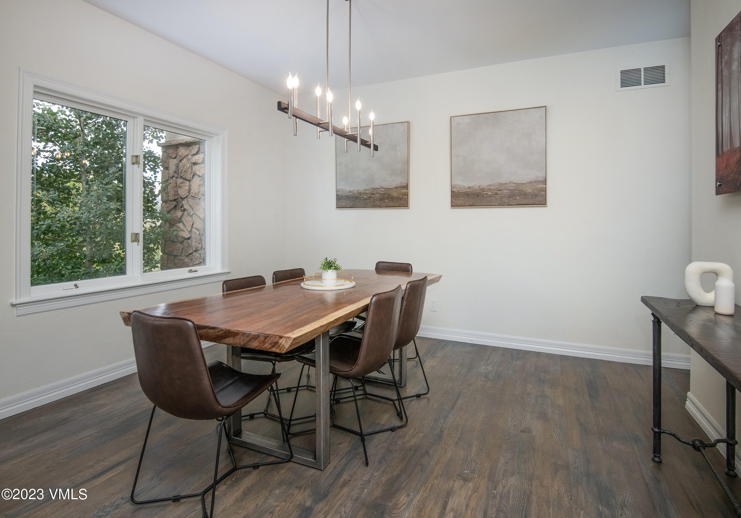 305 Red Fox Gypsum, CO 81637 - Photo 17 of 50 a view of a dining room with furniture window and wooden floor