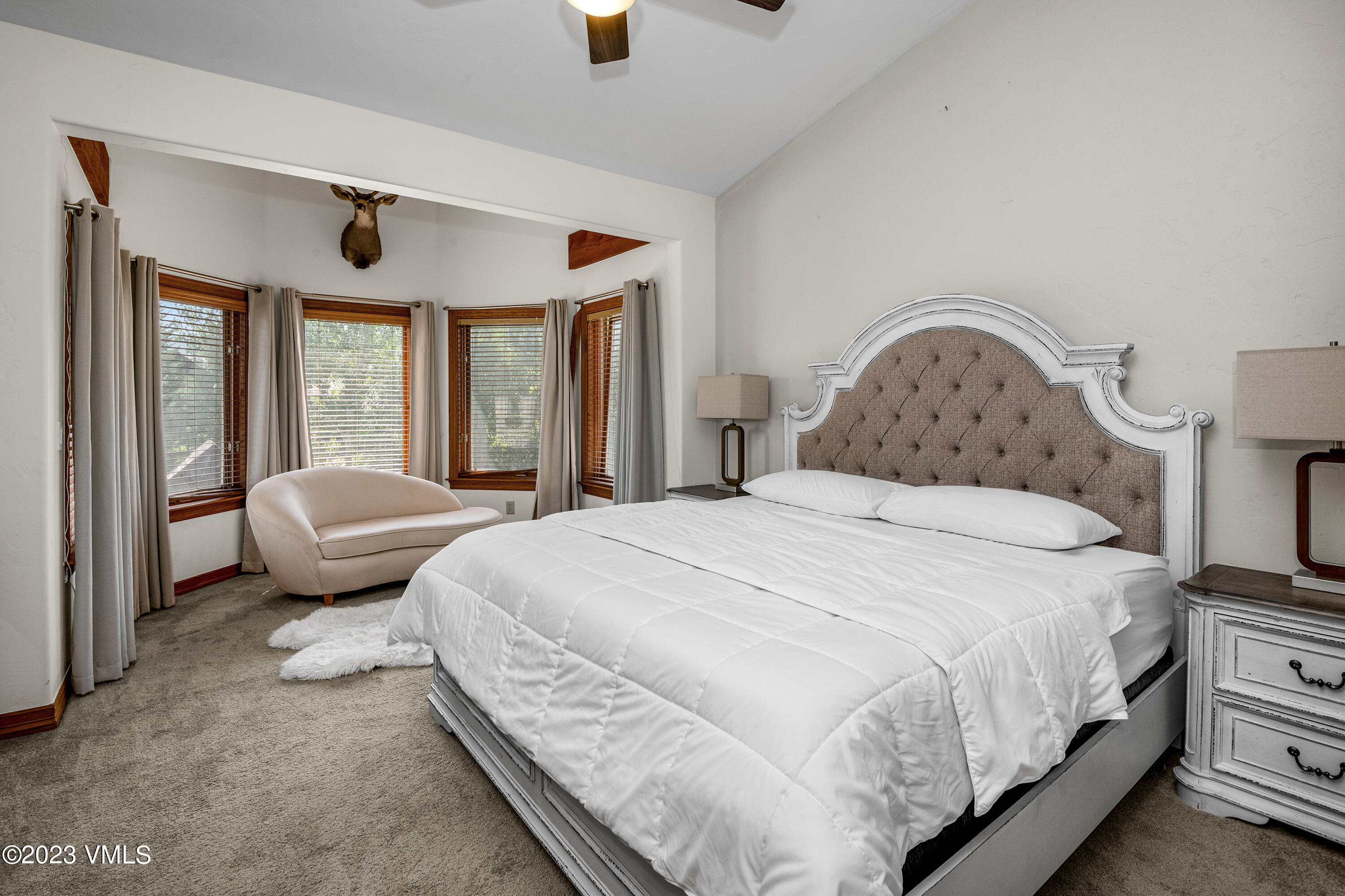 305 Red Fox Gypsum, CO 81637 - Photo 21 of 50 a bedroom with a bed and large windows