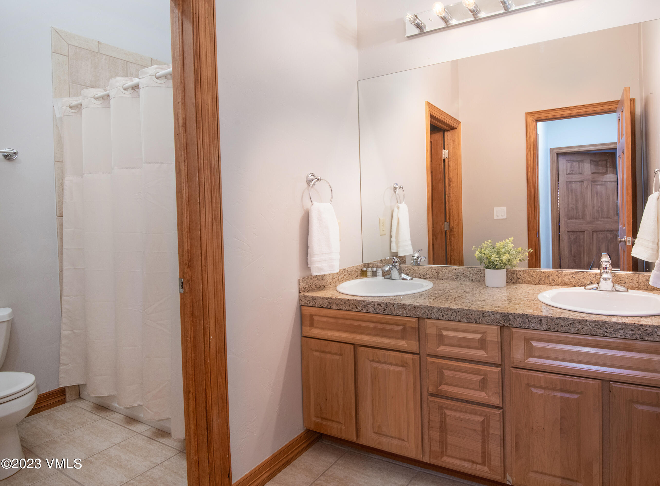 305 Red Fox Gypsum, CO 81637 - Photo 27 of 50 a bathroom with a granite countertop sink and a mirror
