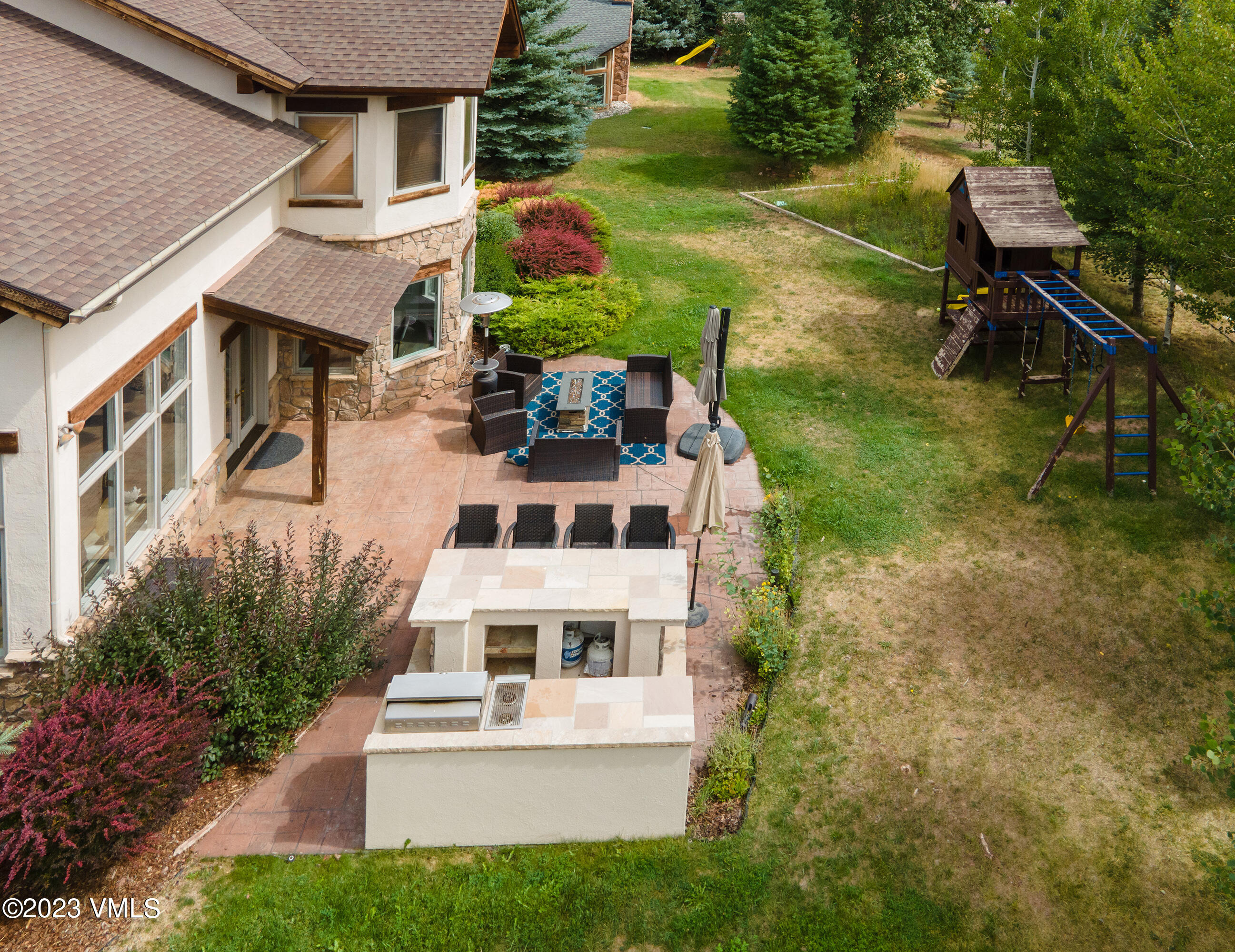 305 Red Fox Gypsum, CO 81637 - Photo 41 of 50 a view of a yard with plants and a bench