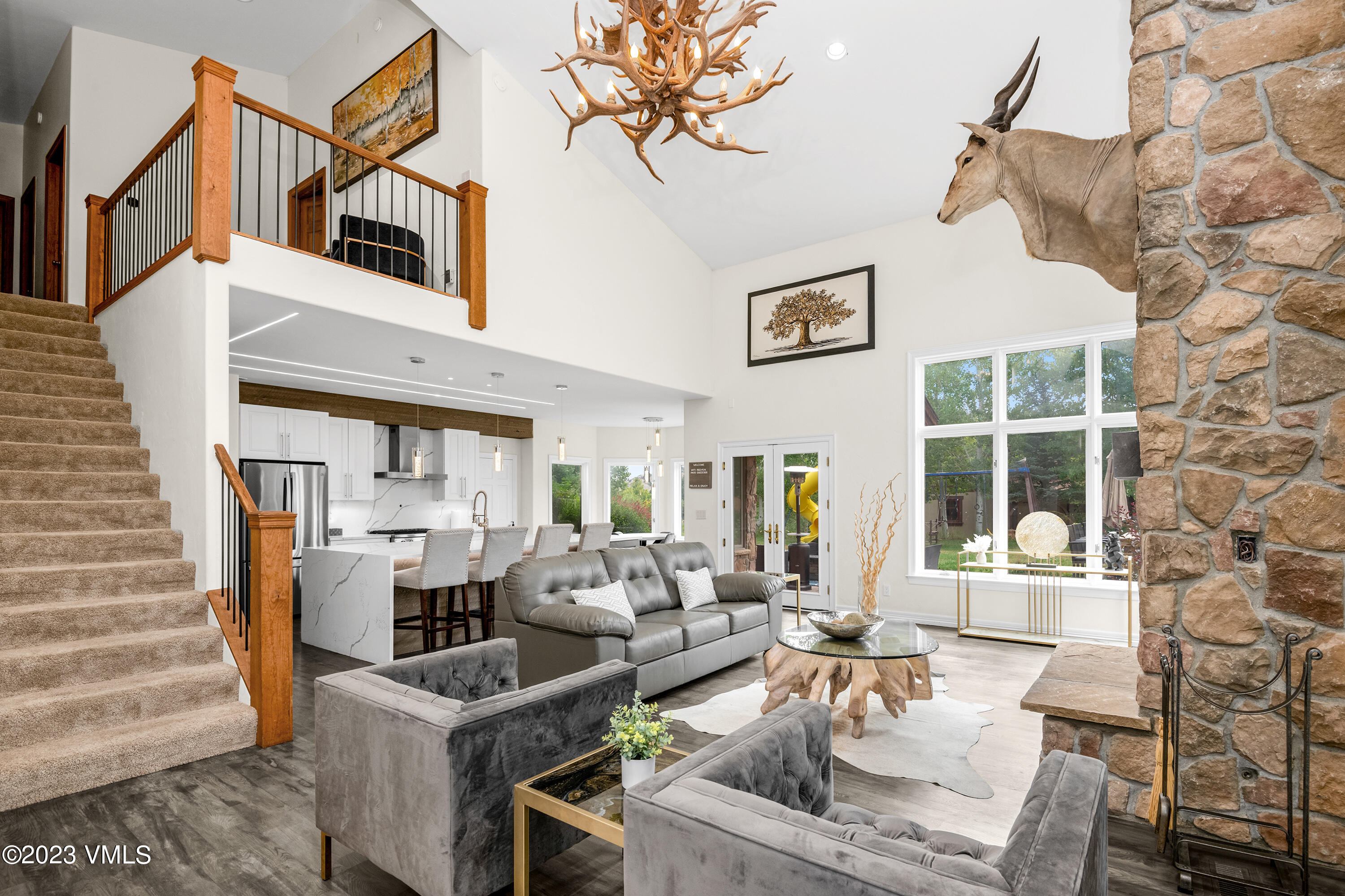 305 Red Fox Gypsum, CO 81637 - Photo 8 of 50 a living room with furniture a fireplace and a chandelier