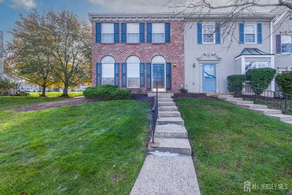 a front view of a brick house with a yard