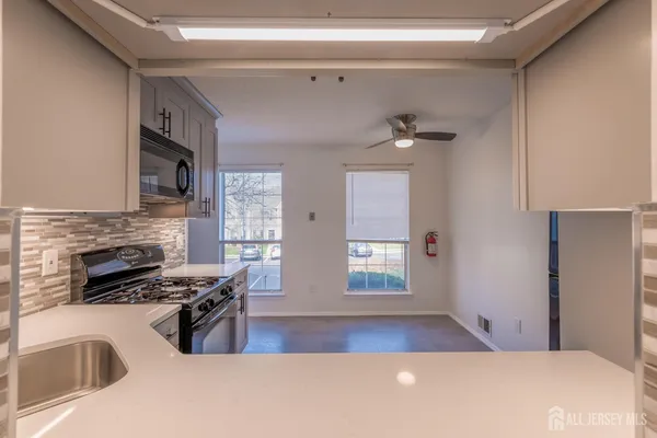 a view of a livingroom with furniture and a kitchen