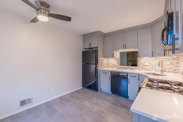 a kitchen with stainless steel appliances granite countertop a refrigerator stove and sink