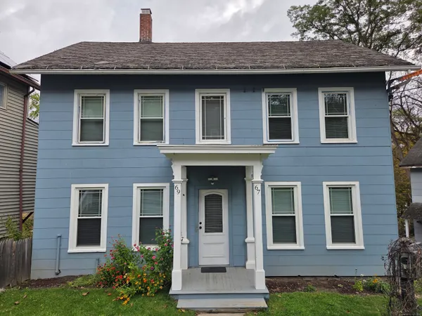 a front view of a house with garden