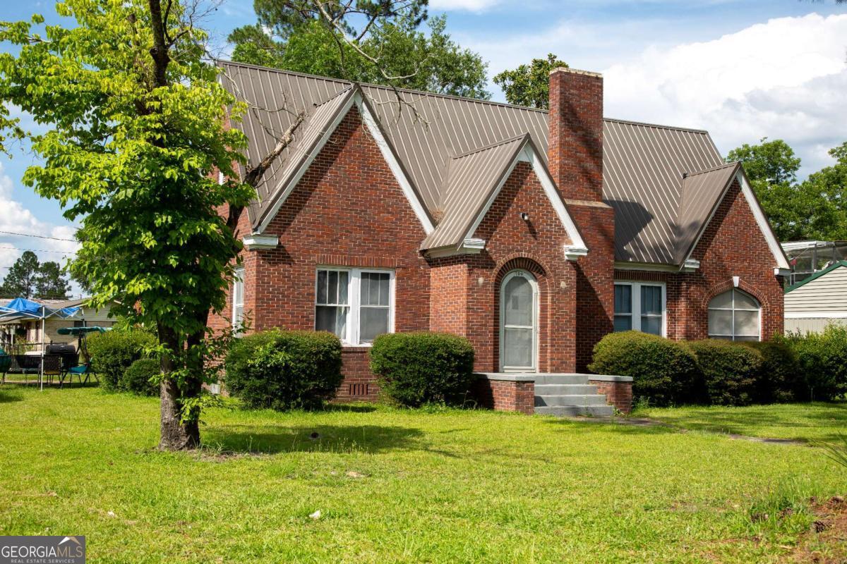 199 Anthony Street Baxley, GA 31513 - Photo 1 of 4 a front view of a house with a yard