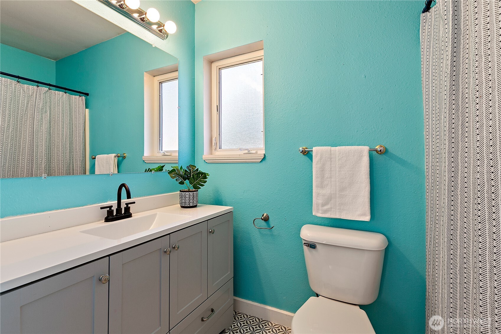 9880 Fredrickson Road Northwest Bremerton, WA 98311 - Photo 16 of 28 a bathroom with a toilet sink and mirror