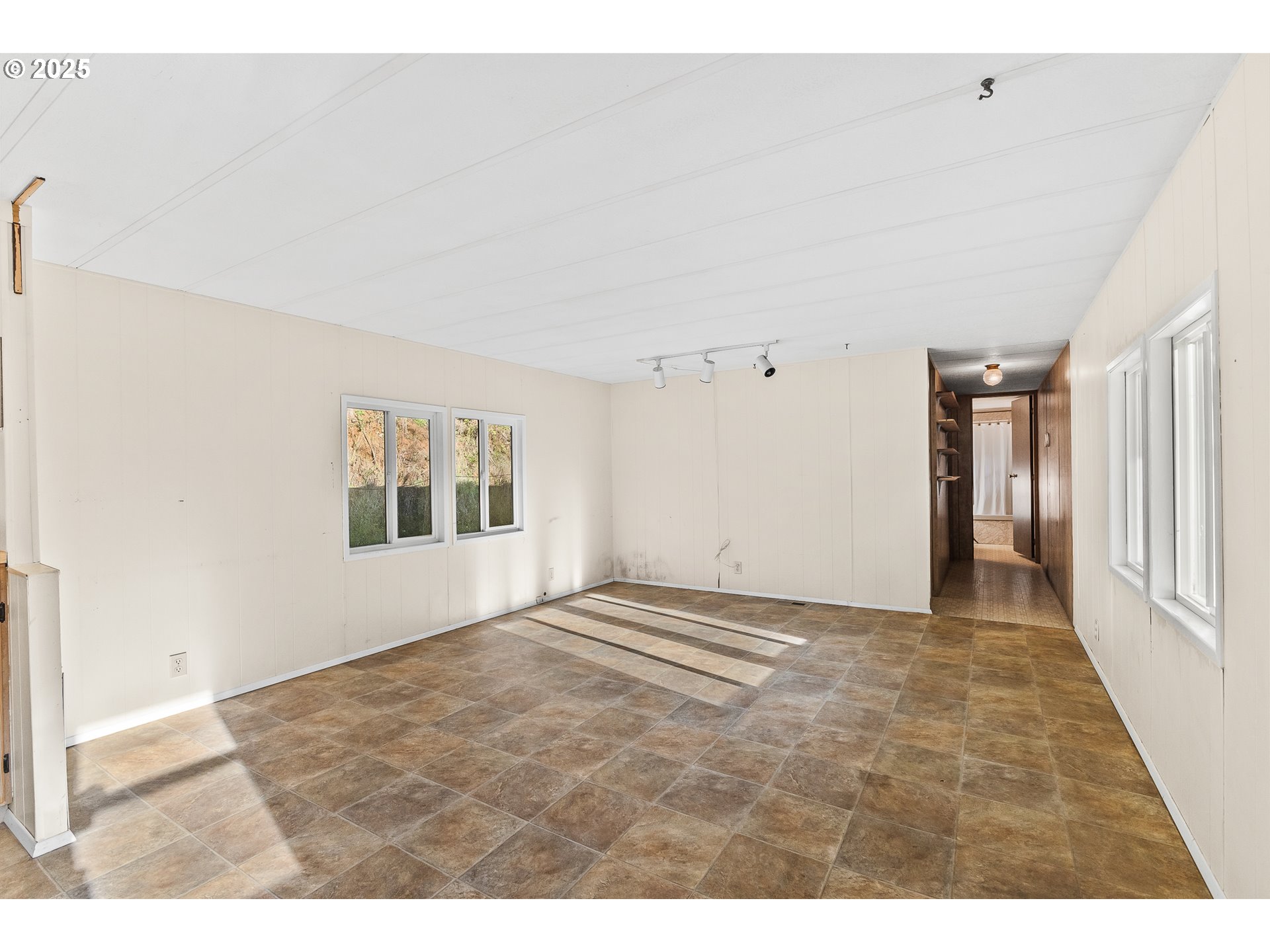 15779 Highway 42 Myrtle Point, OR 97458 - Photo 5 of 33 a view of an empty room with wooden floor and a window