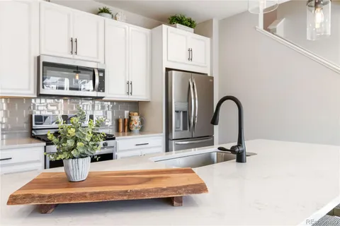 a kitchen with sink and white cabinets