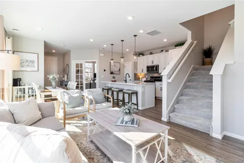 a living room with furniture and wooden floor