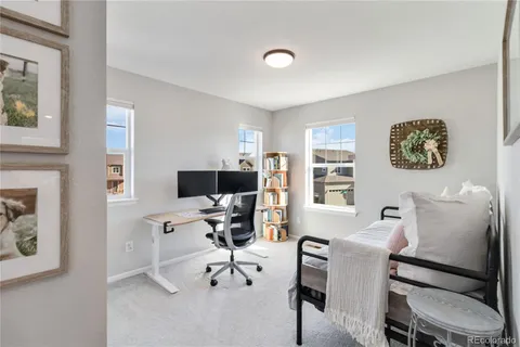 a workspace with furniture and painting on the wall