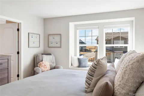 a bedroom with a bed and a couch