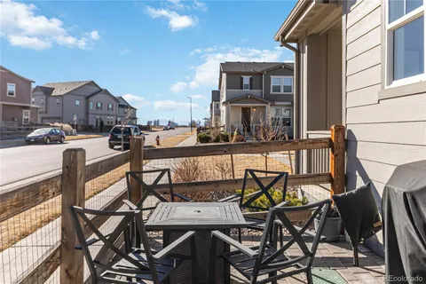 a view of a patio with table and chairs and potted plants
