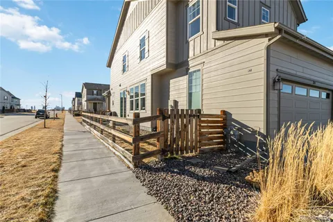 a view of a house with wooden fence