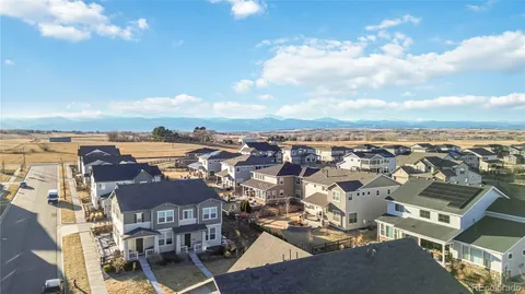 an aerial view of a city with lots of residential buildings ocean and mountain view in back