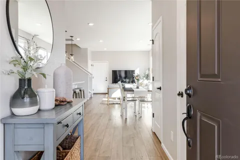 a view of living room with furniture and wooden floor