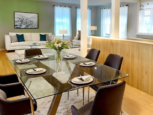 a view of a dining room with furniture and wooden floor