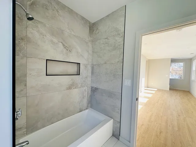 a bathroom with a bathtub and shower