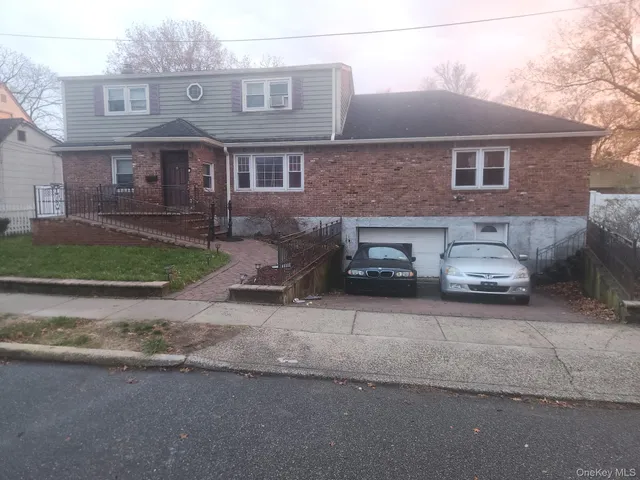 a car parked in front of a brick house