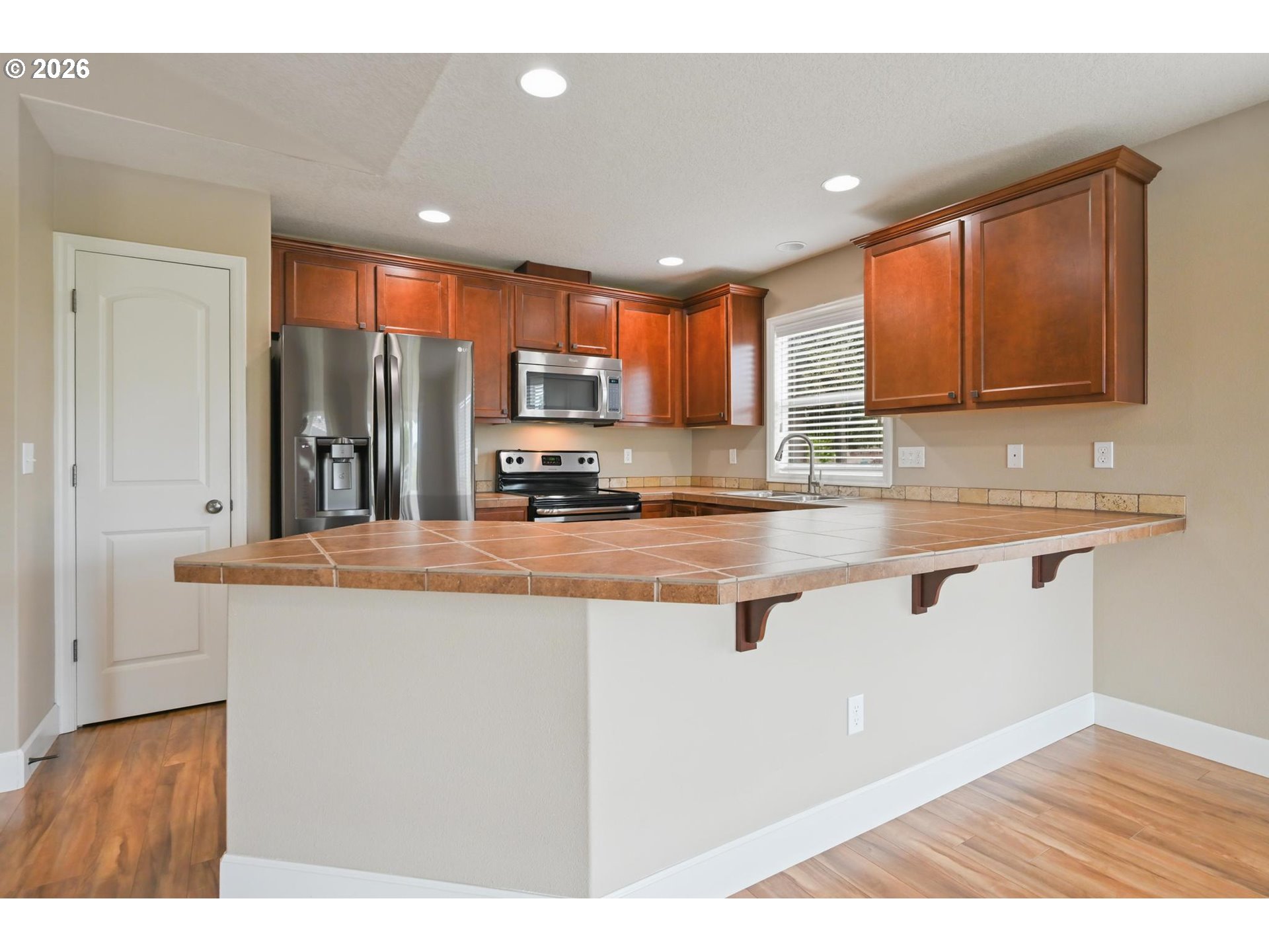 1075 Sage Street Silverton, OR 97381 - Photo 25 of 46 a kitchen with stainless steel appliances granite countertop a sink a stove a microwave a counter top space and cabinets