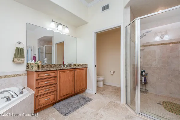 a bathroom with a granite countertop sink mirror and shower
