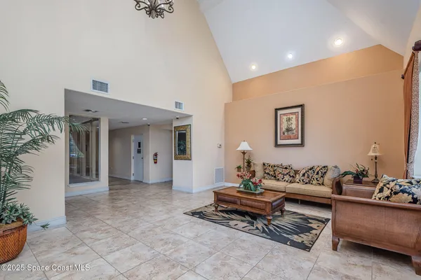a living room with furniture and a potted plant