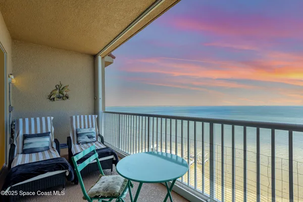 a view of a balcony with chairs