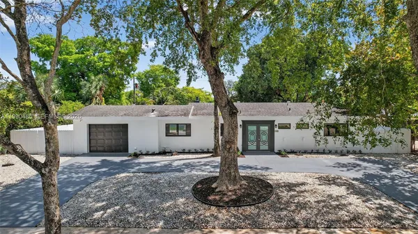 a kitchen with stainless steel appliances granite countertop a refrigerator a sink and a stove
