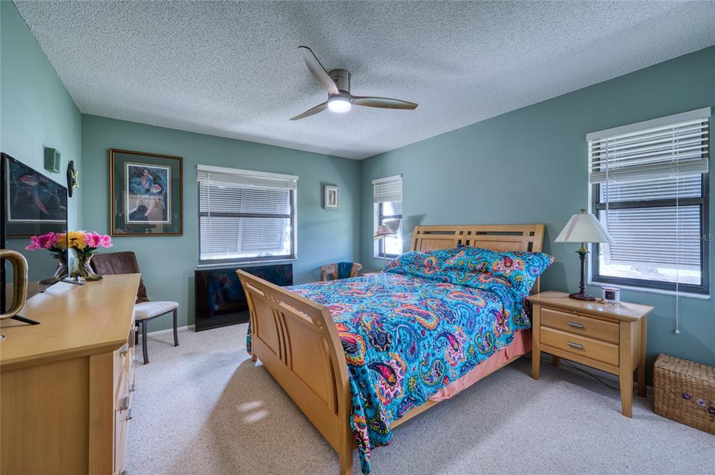 76 Sandstone Circle Venice, FL 34293 - Photo 12 of 37 a bedroom with a bed and a flat screen tv