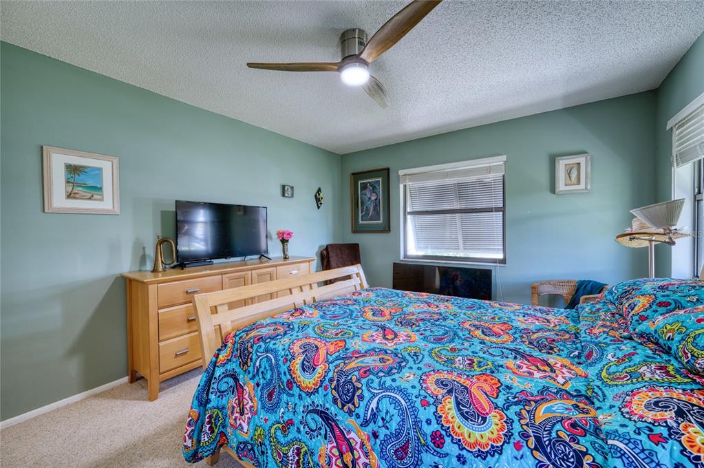 76 Sandstone Circle Venice, FL 34293 - Photo 13 of 37 a bedroom with a bed and a flat screen tv