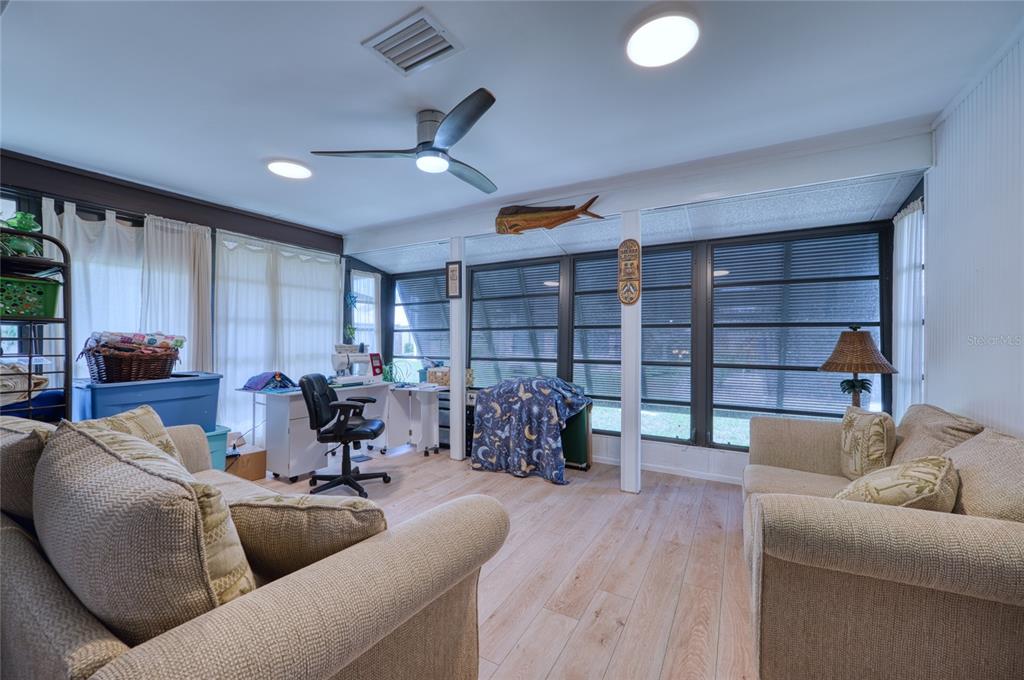 76 Sandstone Circle Venice, FL 34293 - Photo 17 of 37 a living room with furniture and a book shelf