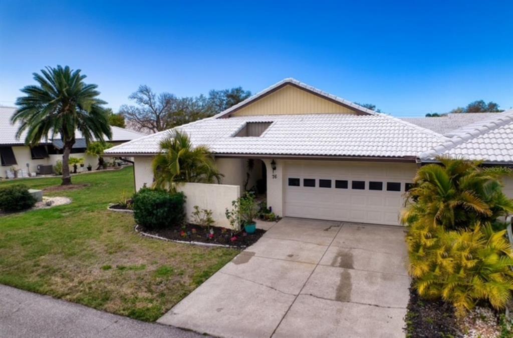 76 Sandstone Circle Venice, FL 34293 - Photo 25 of 37 a view of a house with a yard and potted plants