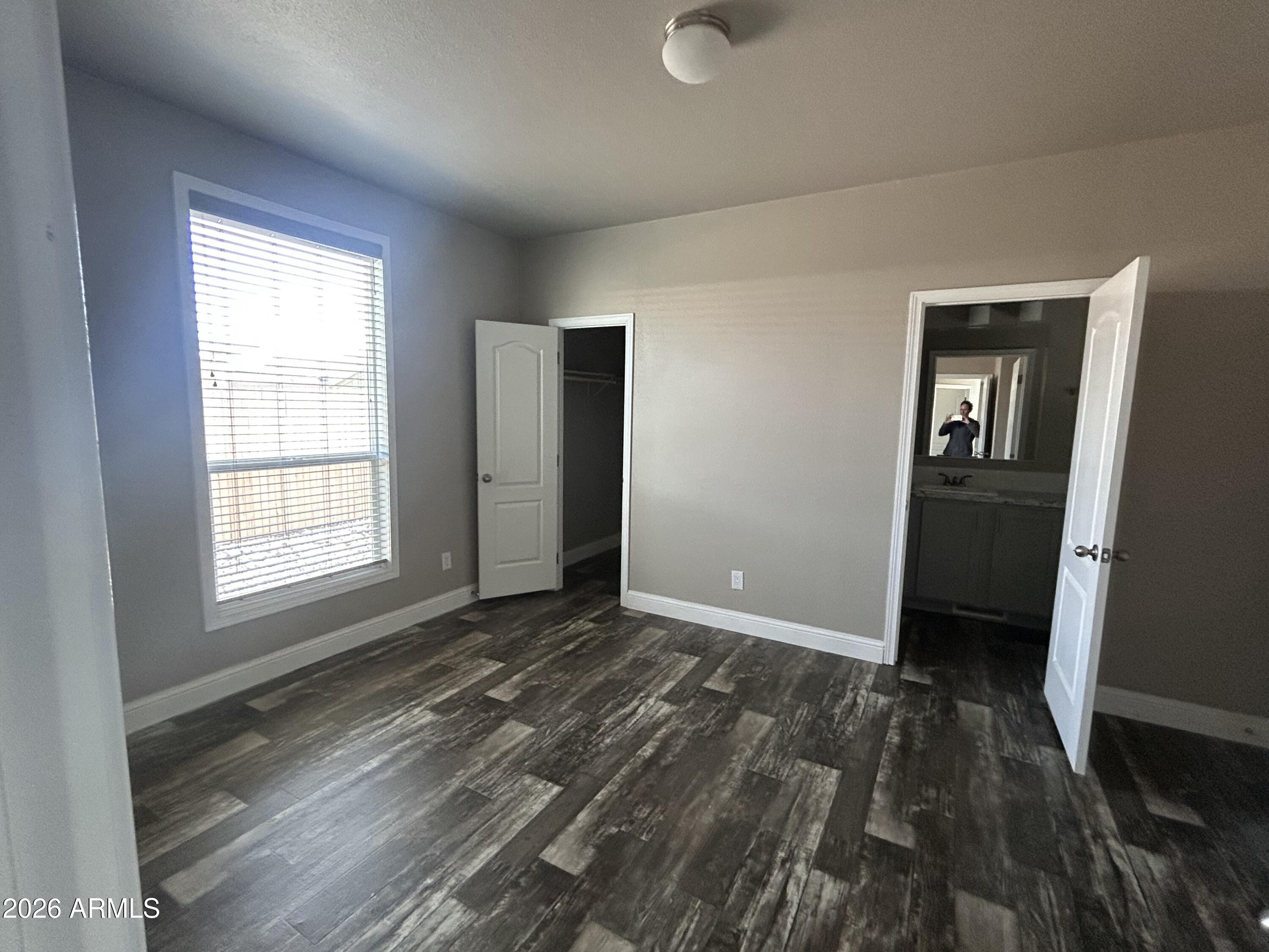 1067 Thorton Road Camp Verde, AZ 86322 - Photo 14 of 21 wooden floor in an empty room with a window