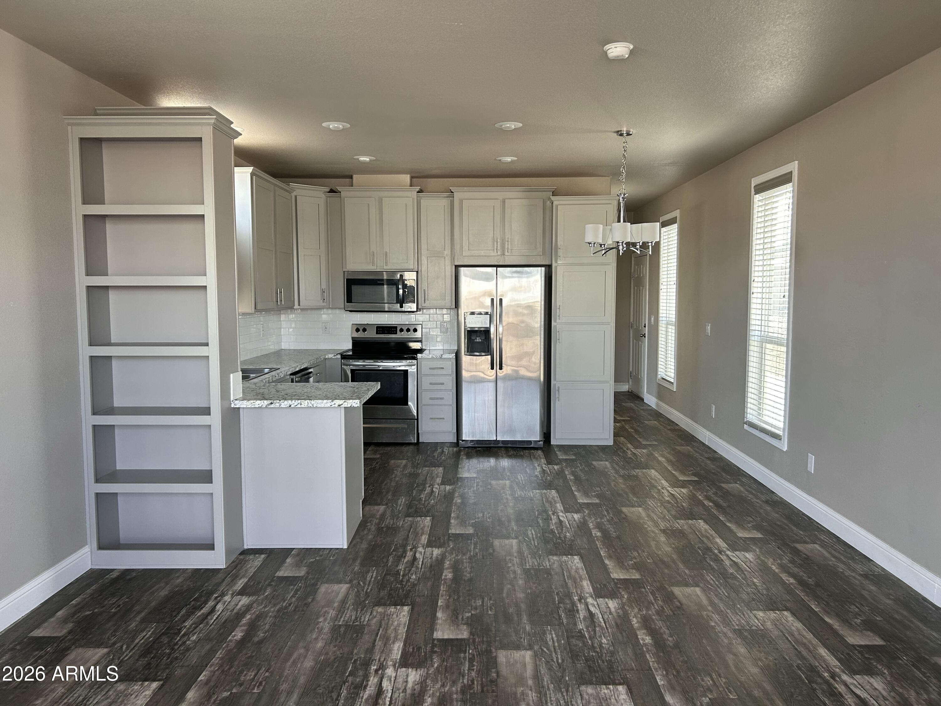 1067 Thorton Road Camp Verde, AZ 86322 - Photo 6 of 21 a kitchen with a refrigerator and a stove top oven