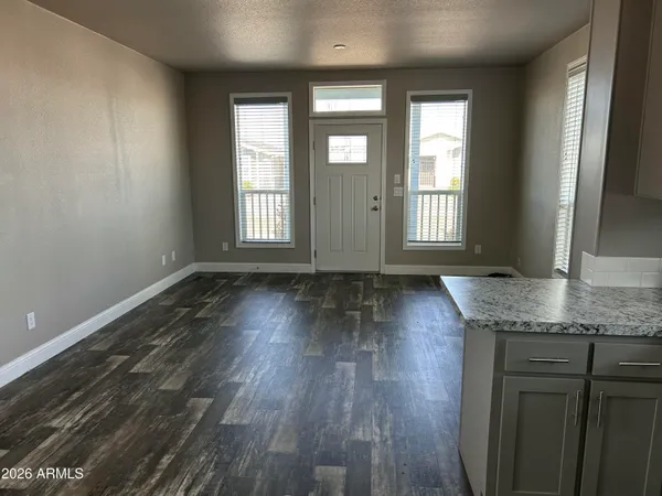 an empty room with wooden floor and a window