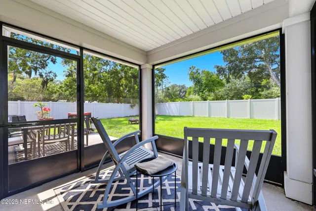 a view of a chairs and table in the balcony