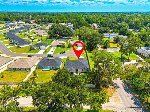 an aerial view of residential houses with outdoor space and swimming pool