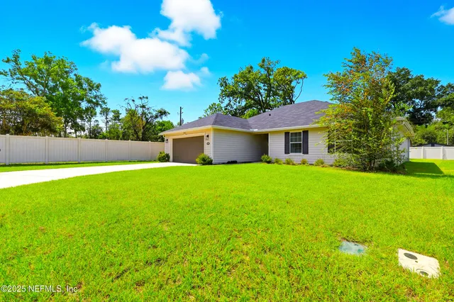 a front view of house with yard and green space