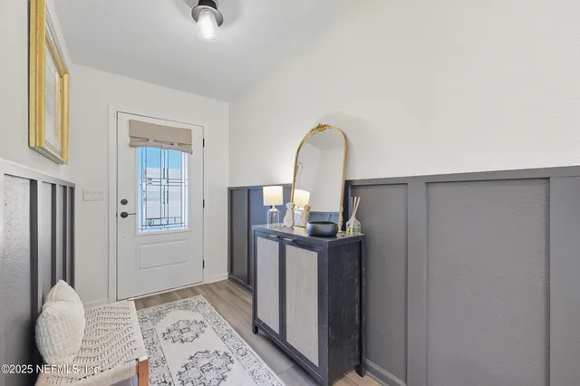 a view of a kitchen with furniture and a refrigerator