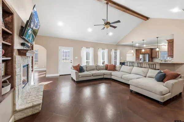 a kitchen with stainless steel appliances granite countertop a sink refrigerator and cabinets
