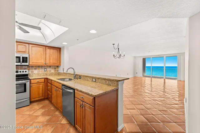 a bathroom with a granite countertop sink a toilet a mirror and shower