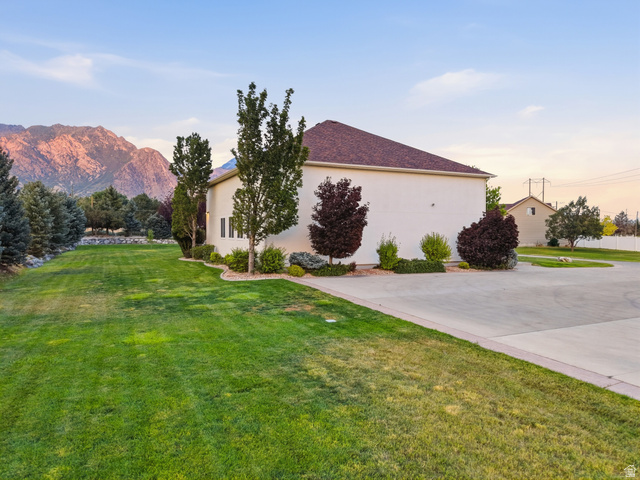 702 Alpine Highway Alpine, UT 84004 - Photo 81 of 83 Spacious exterior featuring a light-colored facade, brown shingle roof, extensive green lawn, mature trees, and a concrete driveway