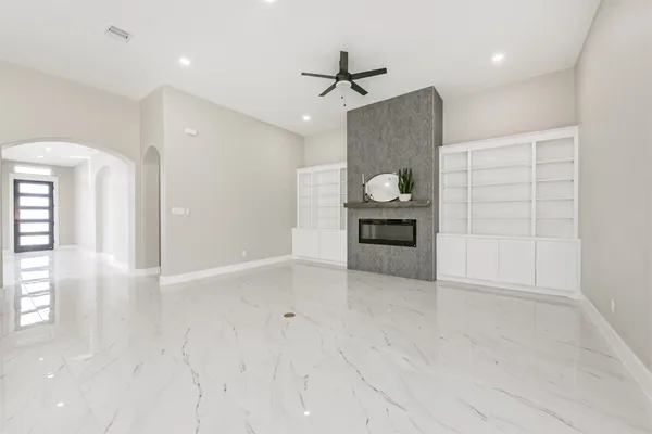 en empty room with wooden floor cabinet and windows