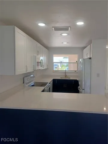 a kitchen with stainless steel appliances a refrigerator and a sink