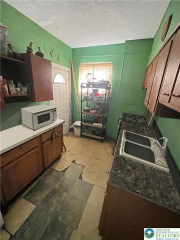 a kitchen with a sink and a stove top oven