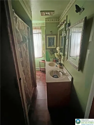 a bathroom with sink a mirror a bathtub and shower