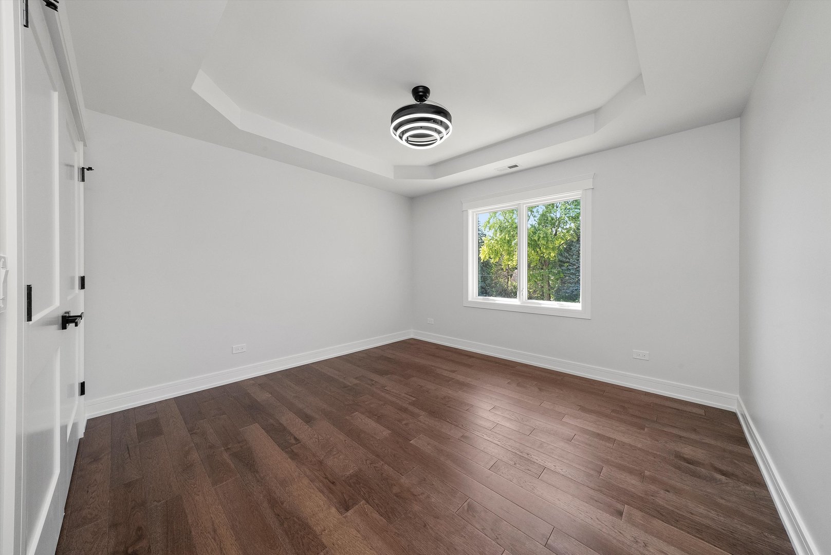 10441 South 83rd Avenue Palos Hills, IL 60465 - Photo 30 of 47 an empty room with wooden floor fan and windows