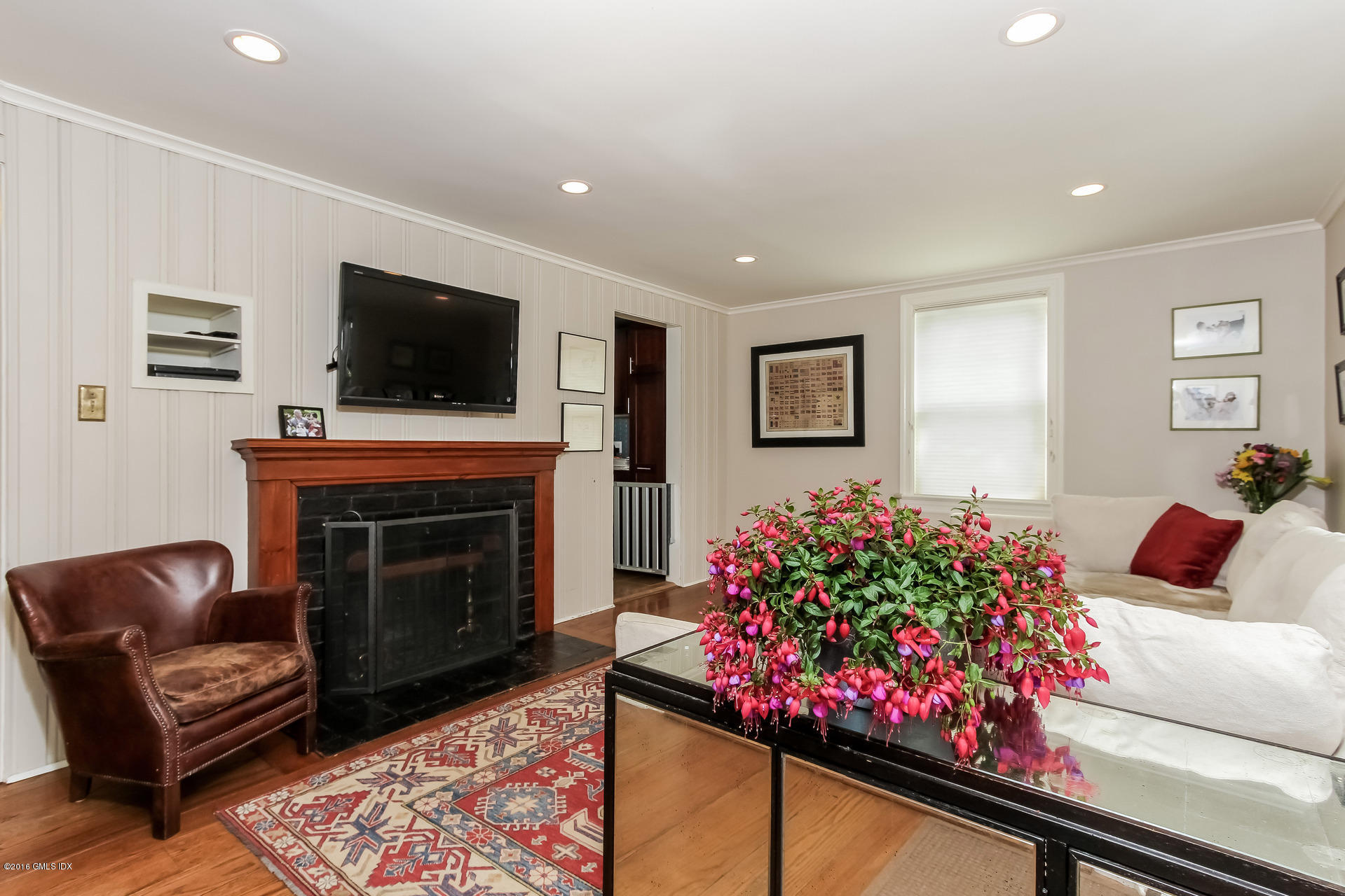 3 Idlewild Manor Greenwich, CT 06830 - Photo 11 of 26 a living room with furniture a flat screen tv and a fireplace