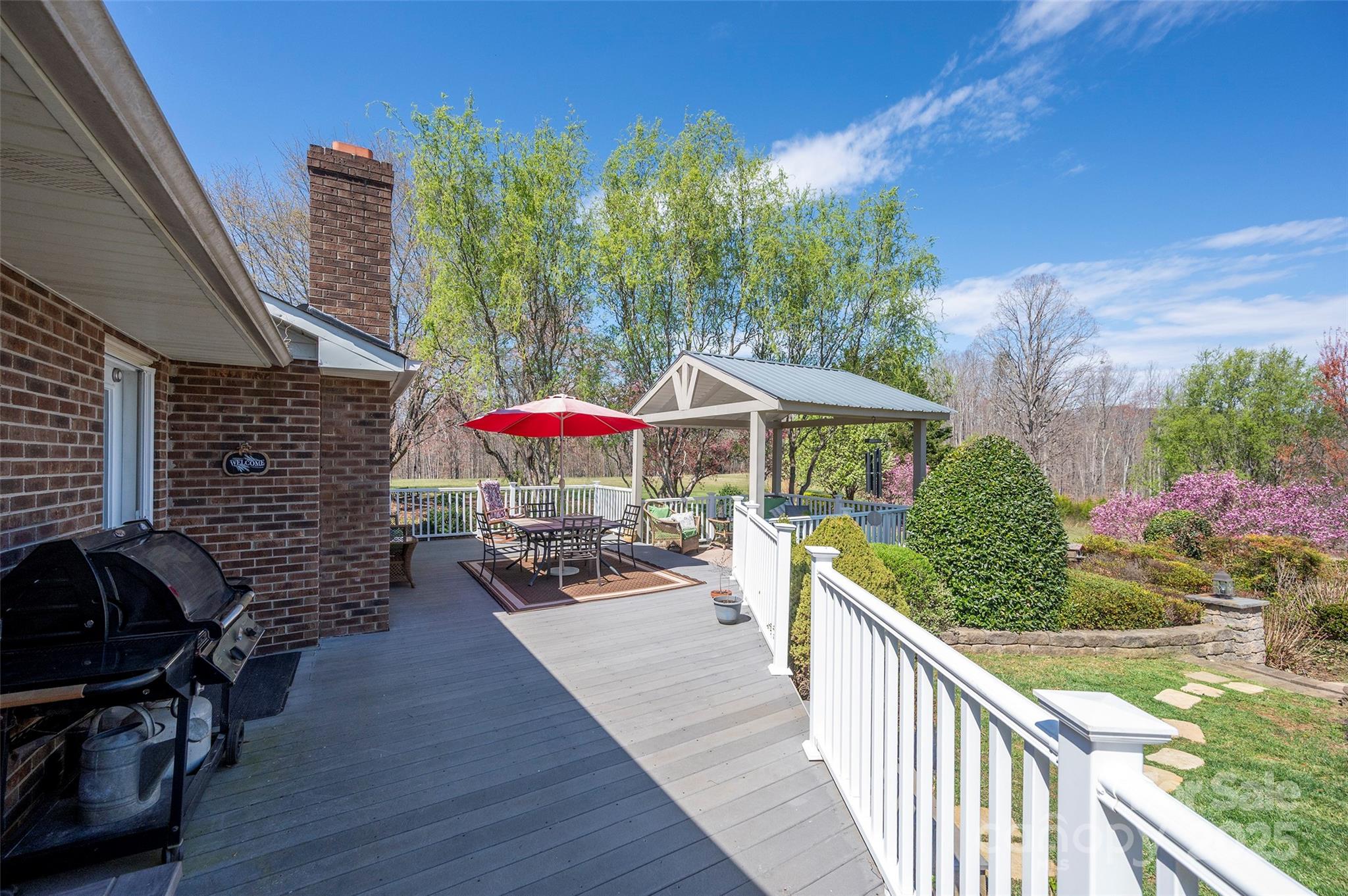 1120 Fred Merritt Road King, NC 27021 - Photo 11 of 45 a view of a patio with chairs under an umbrella